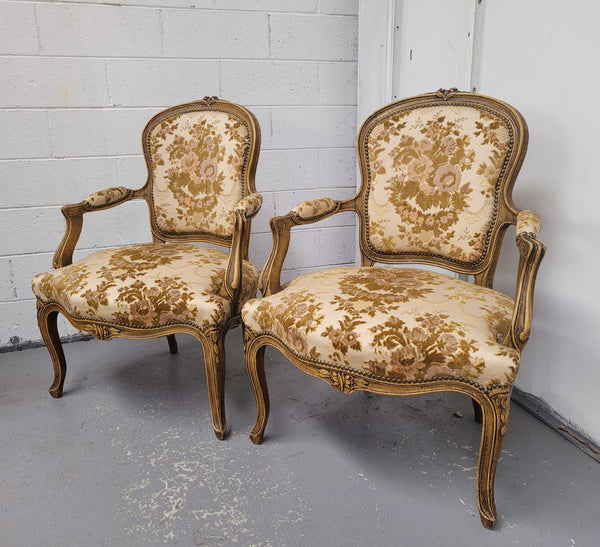 Beautiful pair of French Walnut late 19th Century Louis XV style upholstered arm chairs with original paint. These chairs have extra wide seats and are very comfortable and in good original condition. The upholstery is in good used condition meaning it can be used as is or reupholstered for a different look.
