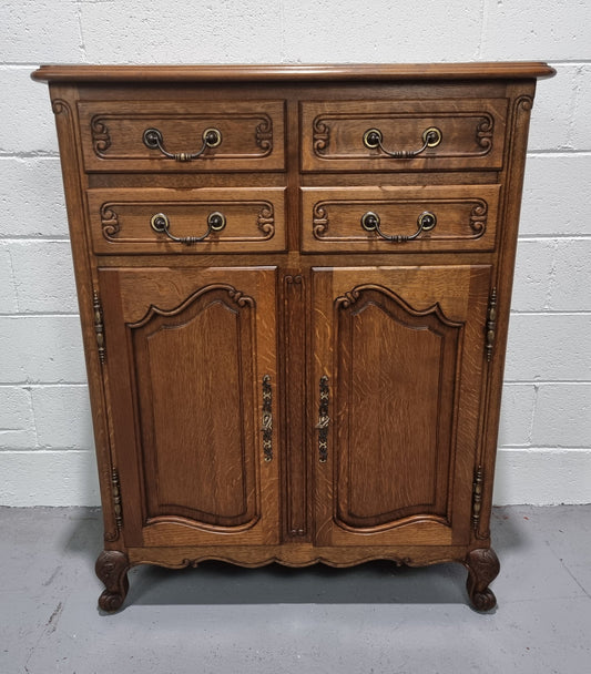 French Oak Louis XV style side cabinet. It has three drawers in total, two small drawers and one deep drawer. In good original detailed condition.