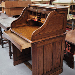 Charming petite English Oak fitted roll top desk. It has a very lovely fitted interior and a drawer at the front ideal for a unit or apartment. Sourced locally and in good original detailed condition.