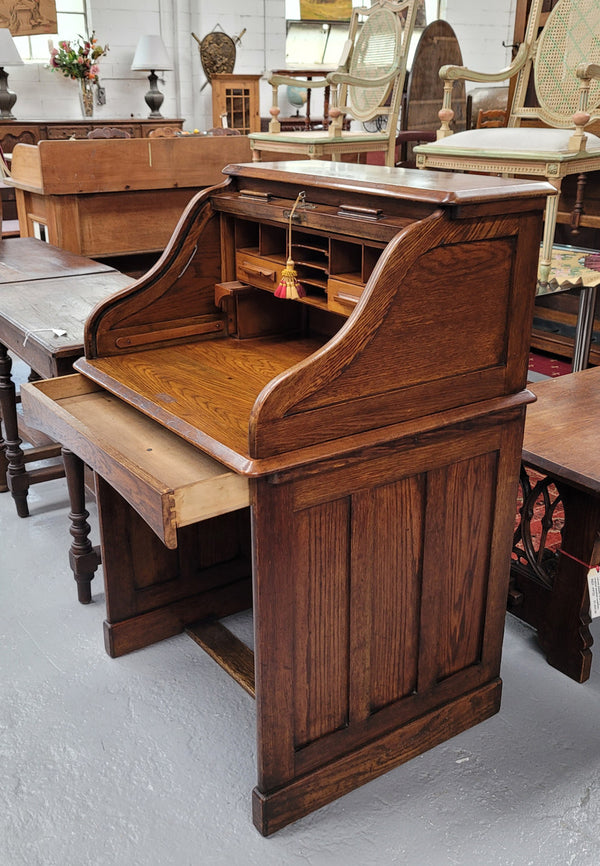 Charming petite English Oak fitted roll top desk. It has a very lovely fitted interior and a drawer at the front ideal for a unit or apartment. Sourced locally and in good original detailed condition.