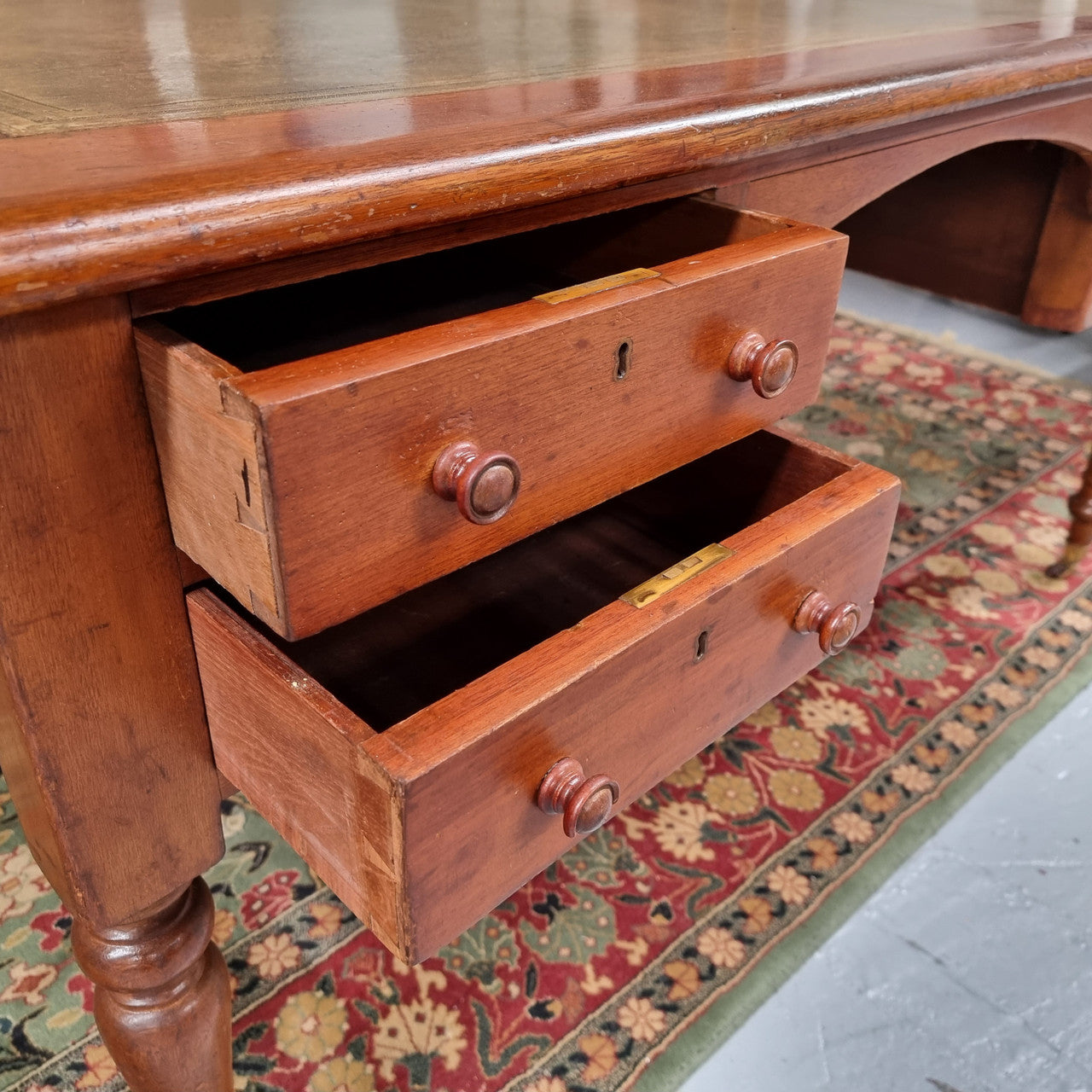 English Cedar full partners desk with attractive tooled leather top, four drawers either side and on caster wheels.  In good original detailed condition.