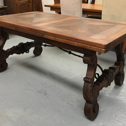 French Oak Renaissance style extension table with a lovely parquetry top and decorative carved and iron base in good original detailed condition.