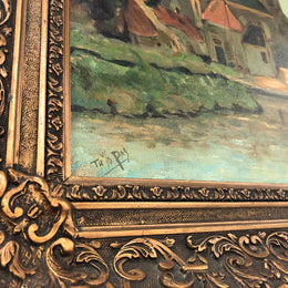 Sourced in France is this lovely oil on canvas town and river scene in a beautiful ornate frame. In good condition.
