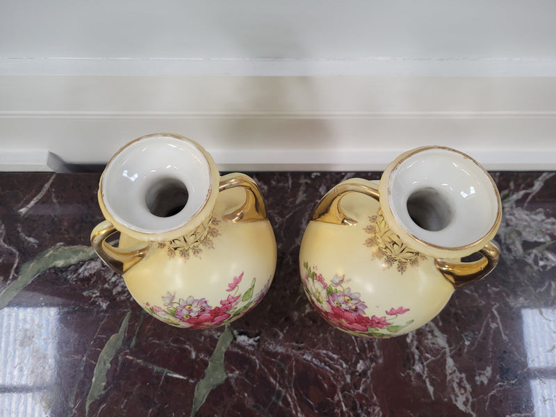 A beautiful pair of Edwardian Austrian hand-painted vases depicting a decorative flower scene. They are in good original condition with no chips or cracks. Please view photos as they help form part of the description.