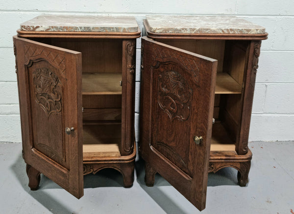 Lovely pair of French oak bedside cabinets with nicely carved details and marble tops. In good original detailed condition.