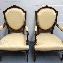 Beautiful pair of Vintage French Walnut Louis XVI style carved Fauteuils with lovely upholstery and wide seats . In good original detailed condition.