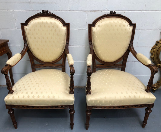 Beautiful pair of Vintage French Walnut Louis XVI style carved Fauteuils with lovely upholstery and wide seats . In good original detailed condition.