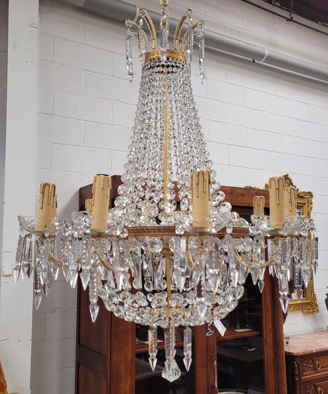 Fine French Empire basket shaped crystal chandelier. Consisting of ten exterior arms and four interior lights. It has stunning crystal's with prism drops. It has been sourced from France fully rewired to Australian standards.