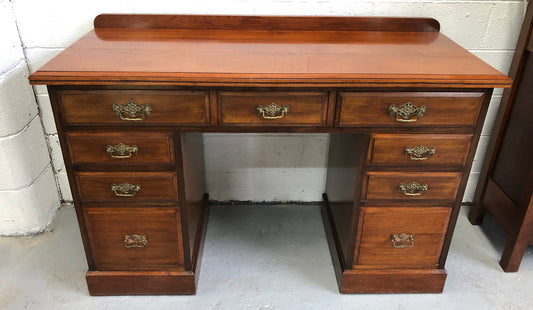 Fabulous small size walnut desk, with nine drawers and decorative brass handles and in good original condition.