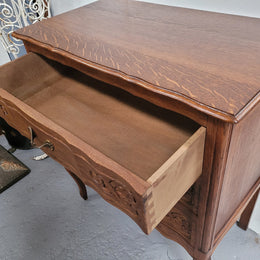 French Oak Louis XV style three drawer commode. It has been sourced from France and has decorative handles and carvings. It is in good original detailed condition.