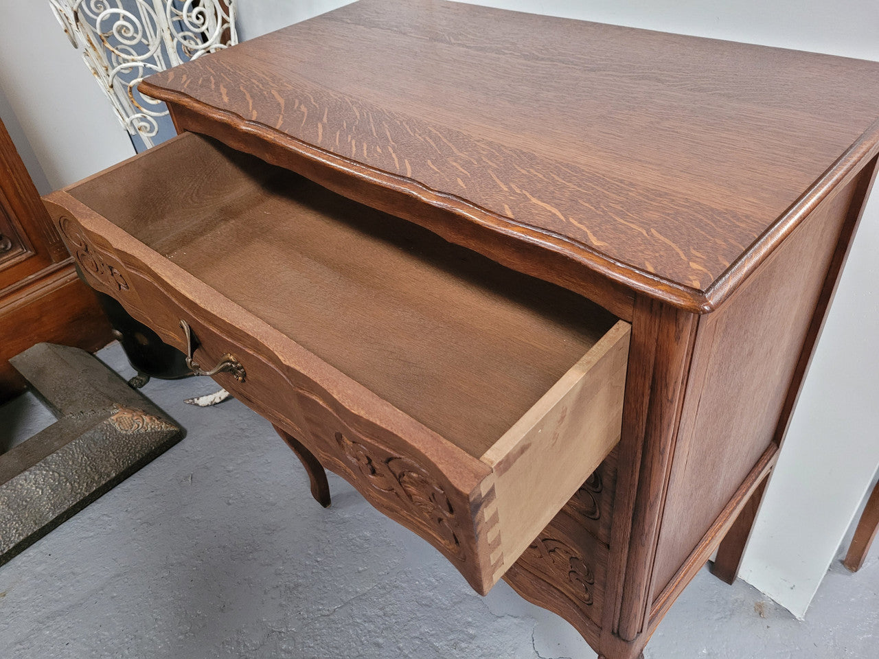 French Oak Louis XV style three drawer commode. It has been sourced from France and has decorative handles and carvings. It is in good original detailed condition.