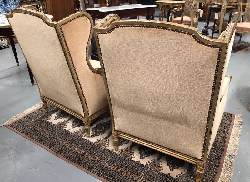 Pair of Vintage French original painted bergere wingback armchairs. The fabric is in very good original condition, please view photos as they help form part of the description. Please note the matching foot stool is being sold separately.