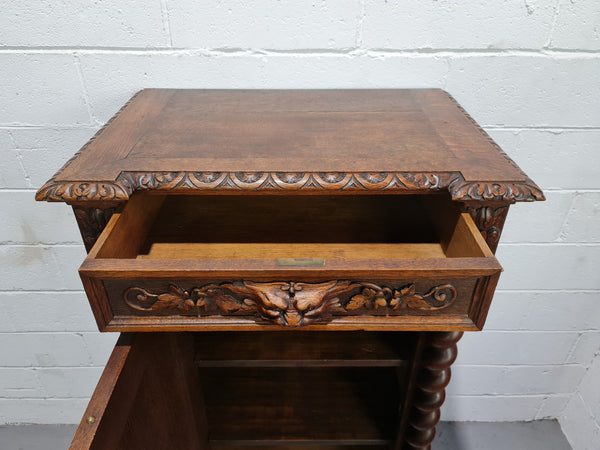 French Henry 2nd Oak Side Cabinet of pleasing narrow proportions.  Carving on the cup board and drawer fronts with barley twist columns.