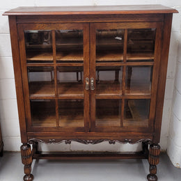 Tudor oak 2 door astral glaze and beveled glass bookcase.  Good original condition. Circa 1930s.