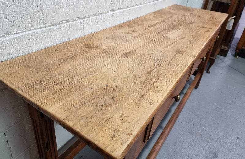 Late 19th Century Cherrywood console table with three drawers. In good used, detailed rustic condition.