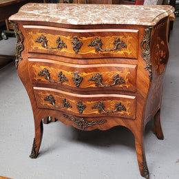 Antique French Louis XV style compact three drawer marble top commode with marquetry inlay and ormolu mounts. Sourced from France and in good original detailed condition.