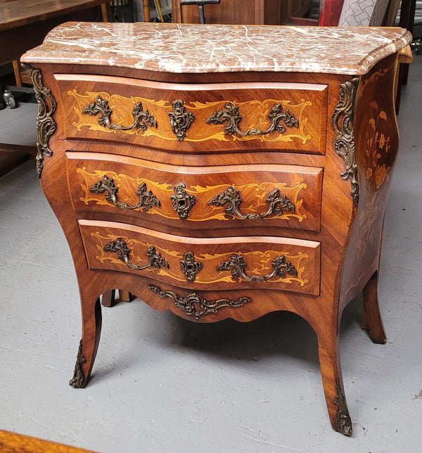 Antique French Louis XV style compact three drawer marble top commode with marquetry inlay and ormolu mounts. Sourced from France and in good original detailed condition.