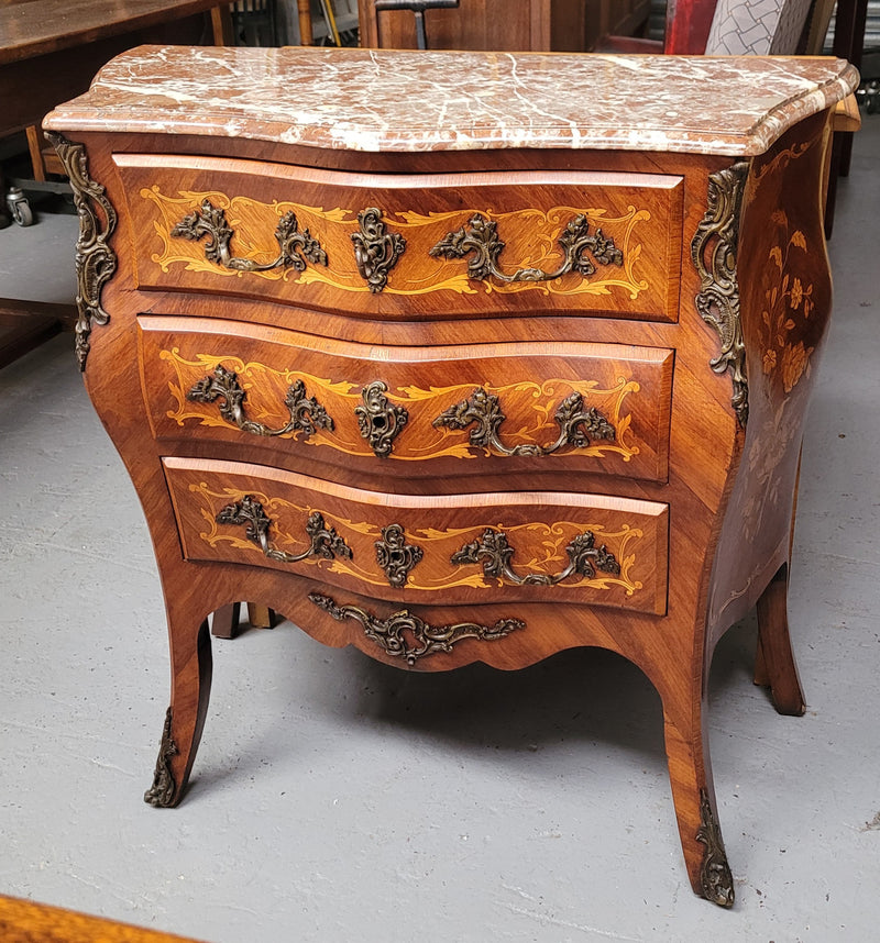 Antique French Louis XV style compact three drawer marble top commode with marquetry inlay and ormolu mounts. Sourced from France and in good original detailed condition.