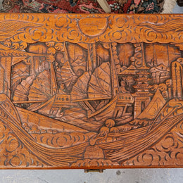 Vintage nicely carved Camphor wood chest. It has amazing carvings of boats, dragons and temples. It is in good original detailed condition.