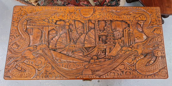 Vintage nicely carved Camphor wood chest. It has amazing carvings of boats, dragons and temples. It is in good original detailed condition.