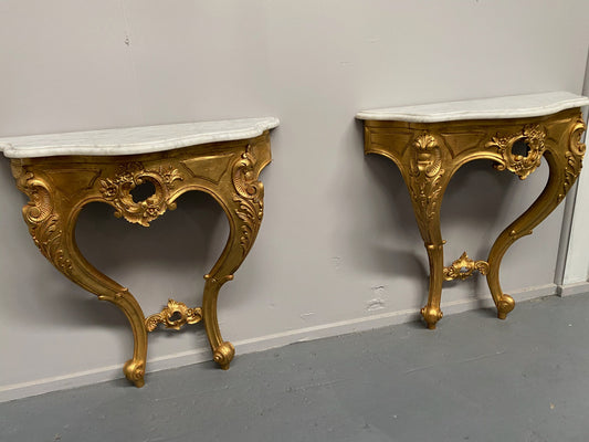 Rare Pair Of Antique carved gilt wood & marble top console tables. They are "wall mounted".