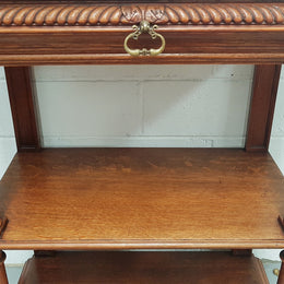 A French 19th century oak carved three tier cabinet. The cabinet/dumbwaiter has carved half border top that can be removed. Drawer for storage and in very good original condition.