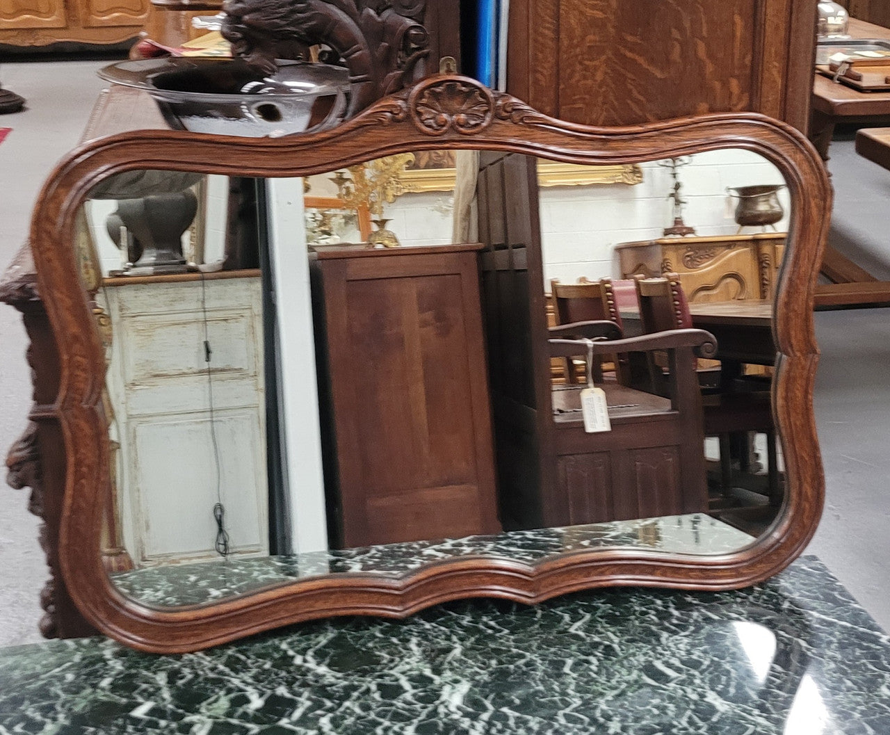 French Louis XV style carved Oak wall mirror. It is in good original detailed condition and has been sourced from France.