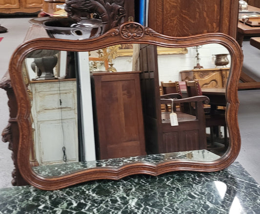 French Louis XV style carved Oak wall mirror. It is in good original detailed condition and has been sourced from France.
