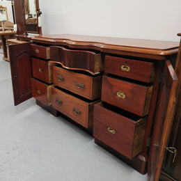 An English Victorian Mahogany sideboard with nine drawers. This amazing piece has loads of storage with three central drawers in the middle and a further six drawers. It has three each side located behind two doors. It has been sourced from locally and in original detailed condition.