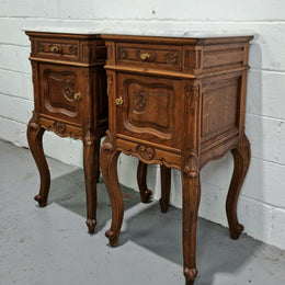 Beautiful pair of French Oak carved Louis XV style bedside cabinets with a white marble top, drawer and cupboard. They are in good original detailed condition.