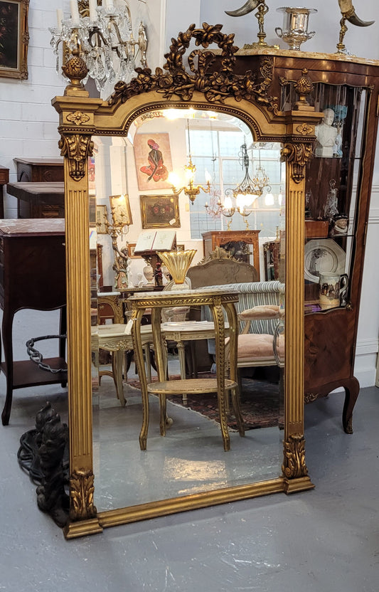 French Louis XVI style Napoleon III (1870’s) gilt mantle mirror. Beautifully carved and decorated with original bevelled mirror showing signs of age. It is in good original detailed condition and has been sourced from France.