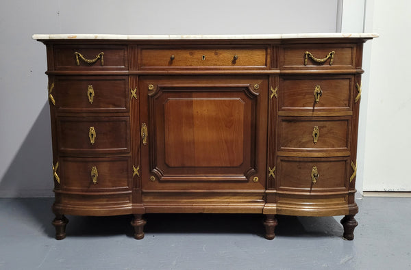 Fabulous French Walnut Louis XVI style cupboard, with a lovely marble top and nine drawers. There is also a cupboard and beautiful ormolu mounts. It is in good original detailed condition.