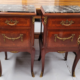 Appealing Louis XV style high quality bedside cabinets with black Portoro marble top and bronze mounts. They have been sourced from France and are in good original condition.