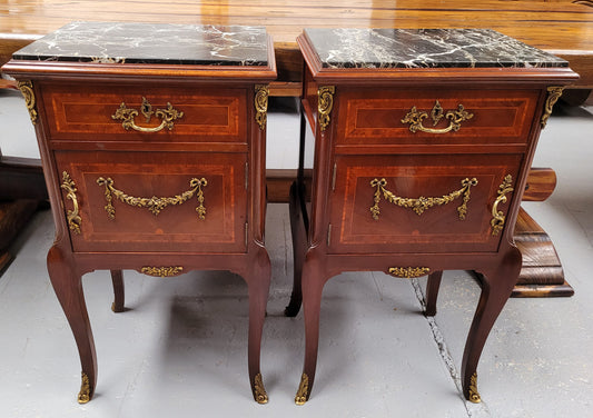Appealing Louis XV style high quality bedside cabinets with black Portoro marble top and bronze mounts. They have been sourced from France and are in good original condition.