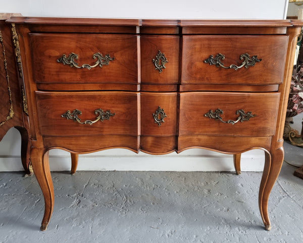 Elegant French Louis XV style Cherrywood commode with two drawers. It is in good original detailed condition.
