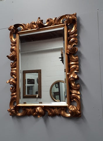 Early 20th Century French Rococo style gilt bevelled wall mirror. It has been sourced from France and is in good original condition. Circa 1920