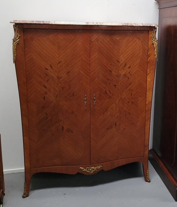 French Louis 15th style Kingwood marquetry inlaid two door cupboard with a beautiful marble top. It has three adjustable shelves and decorative ormolu trim. It has been sourced from France and is in good original detailed condition.