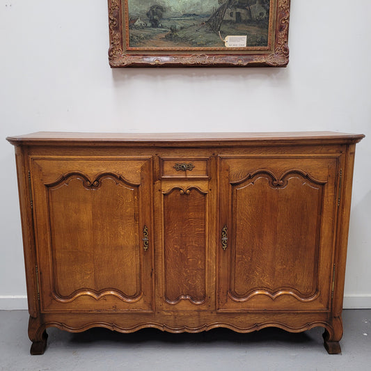 Amazing French Oak early 19th Century two door sideboard with one drawer and two fixed shelves. Sourced from France and in good original detailed condition.