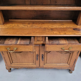 Charming 18th Century French Oak Vaisselier / kitchen dresser with two cupboard doors and three open shelves at the top. Sourced from France and in good original detailed condition.