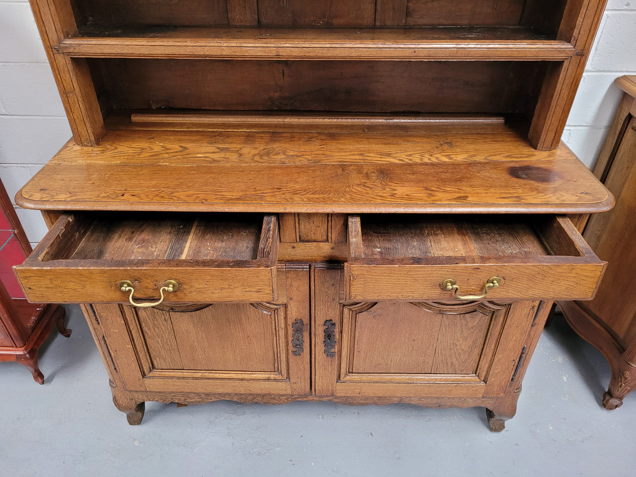 Charming 18th Century French Oak Vaisselier / kitchen dresser with two cupboard doors and three open shelves at the top. Sourced from France and in good original detailed condition.