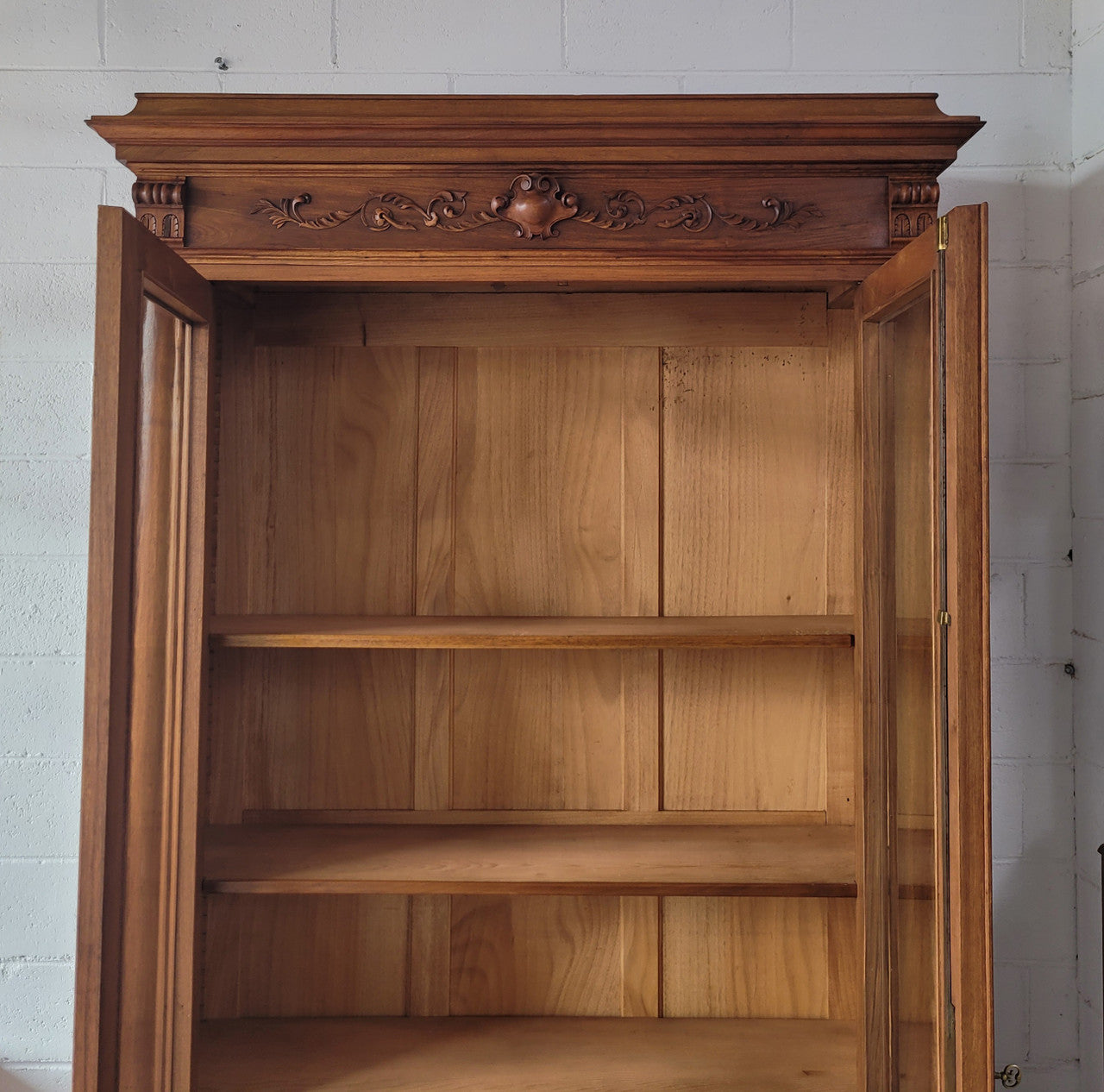 Stunning French Walnut Henry II style two door bookcase with four fully adjustable shelves. The lock on the door is functional and has a key. It is in good original detailed condition.