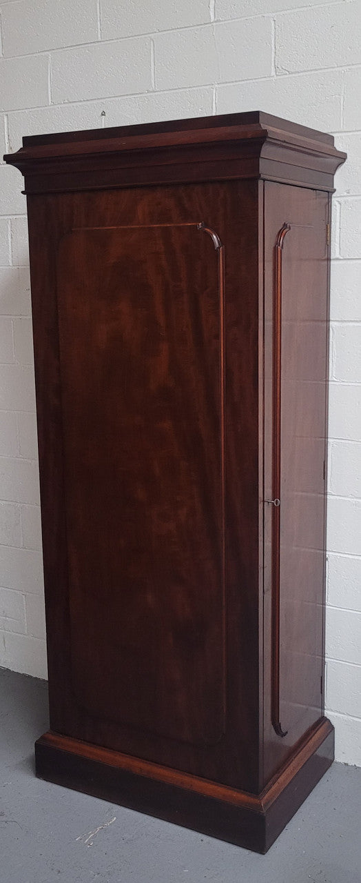 Unusual Victorian Flame Mahogany side wardrobe with side door. It has full hanging and six hooks. The wardrobe opens from a side door which can be locked with its key and has a markers mark stamp on the door. It is in good original condition.