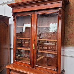 Mid 19th Century Australian Cedar and Flame Cedar tall bookcase. The top has two glass doors that open up to three adjustable shelves followed by a drawer in the middle and finishes with two beautiful wooden doors that open up to a fixed shelf. In good original detailed condition and has been sourced locally.