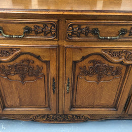French Louis XV style Oak sideboard with beautiful carvings. Plenty Of storage space with four cupboards and two drawers. In very good original detailed condition.