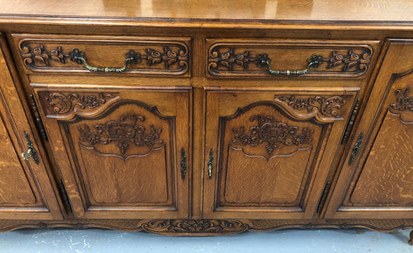 French Louis XV style Oak sideboard with beautiful carvings. Plenty Of storage space with four cupboards and two drawers. In very good original detailed condition.