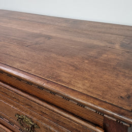 Early 19th Century French Oak chest of three drawers. It has beautiful handles and carvings. It is in good original detailed condition.