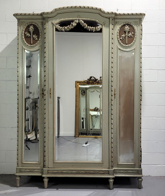 Stunning and desirable Antique French three full length mirror doors, Louis Xl style armoire with original chalk paint finish. With superb carving and decoration. Plenty of storage space with hanging space and shelves.
