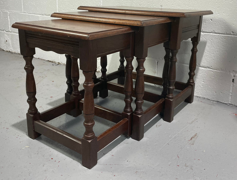 Tudor style English dark Oak nest of three tables. They are in good restored condition.