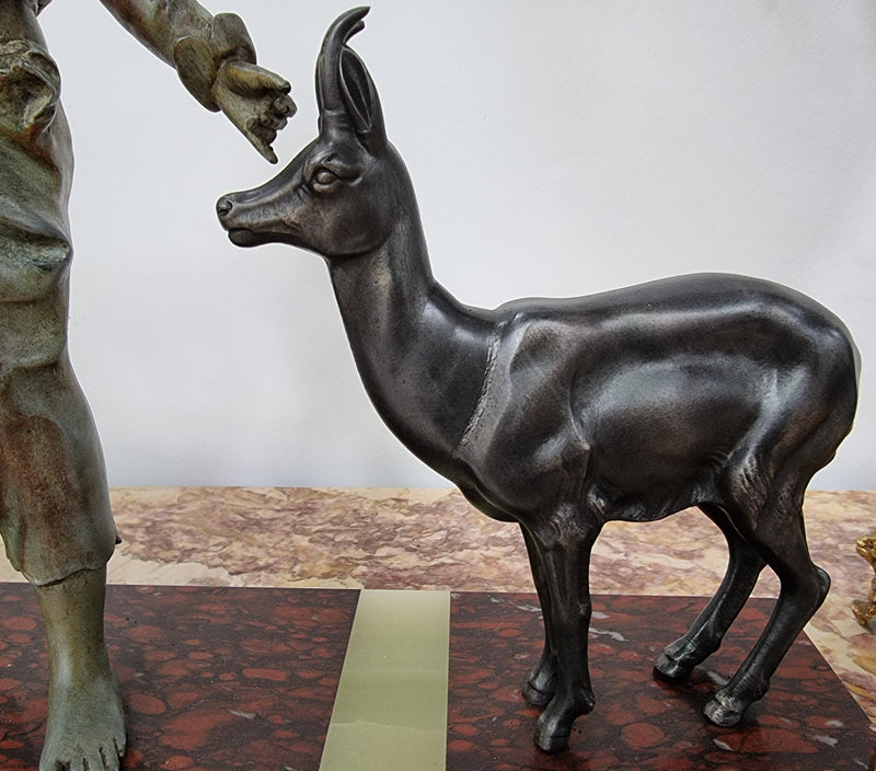 French Art Deco spelter and marble statue of a boy and two deers in good original condition.