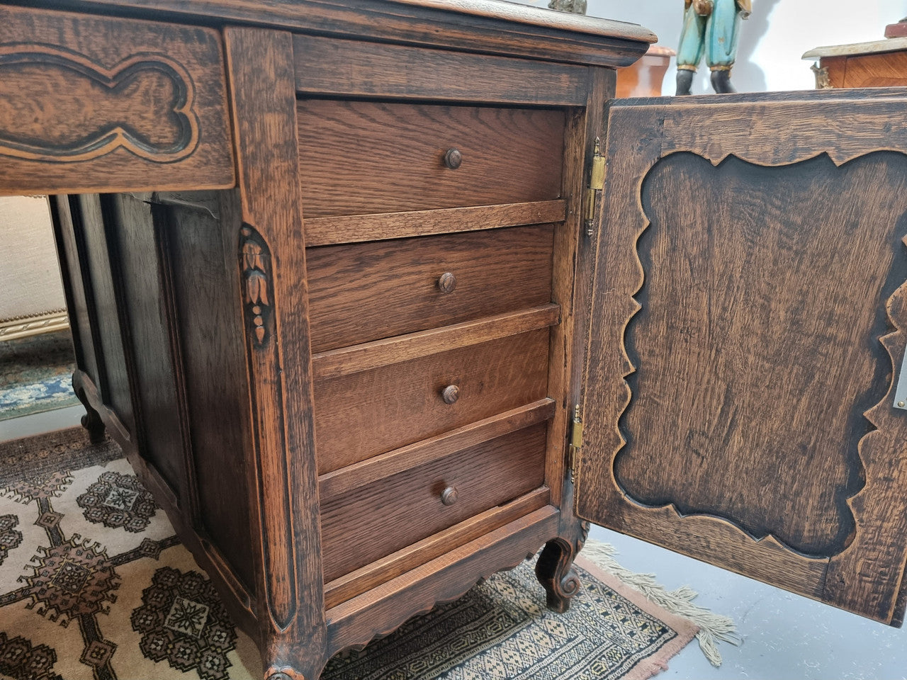 Fabulous Louis XV style French Oak beautifully carved full partners desk. Both sides have a functioning drawer in the middle and two cupboards either side. On both sides one cupboard door opens up to four smaller internal drawers. Plenty of storage space and a large top surface to work on. It is in good original detailed condition.